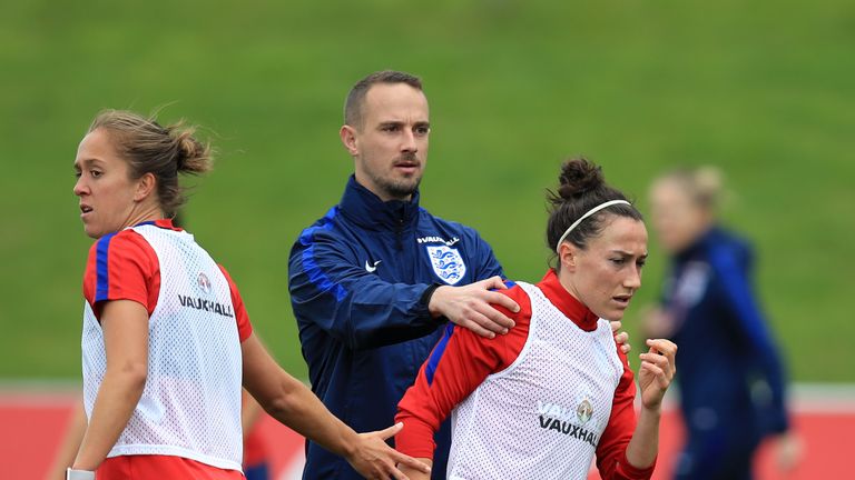 Lucy Bronze appears to shrug off England Women manager Mark Sampson (left) during the training session at St George's Park