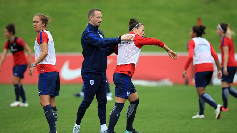 Lucy Bronze appears to shrug off England Women manager Mark Sampson (left) during the training session at St George's Park