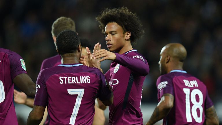 Manchester City's German midfielder Leroy Sane (C) celebrates with teammates after scoring the opening goal of the English League Cup third round football 