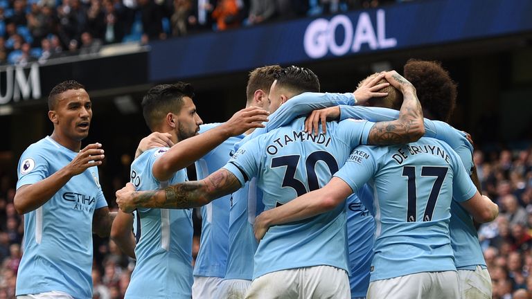 Manchester City's English midfielder Raheem Sterling celebrates with teammates after scoring during the English Premier League football match between Manch