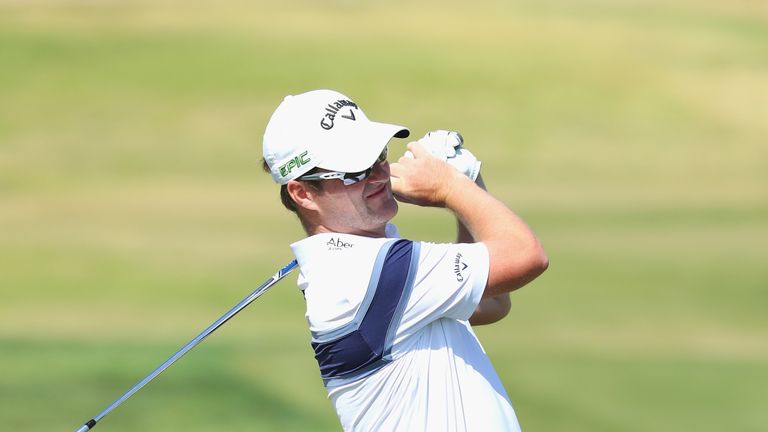 Marc Warren of Scotland plays his second shot into the ninth green during the Portugal Masters