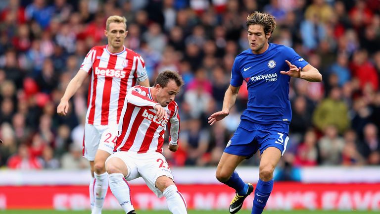 STOKE ON TRENT, ENGLAND - SEPTEMBER 23:  Xherdan Shaqiri of Stoke City controls the ball under pressure of Marcos Alonso of Chelsea during the Premier Leag