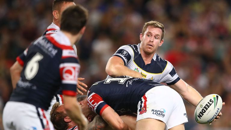 Michael Morgan looks to offload out of the tackle against the Roosters.