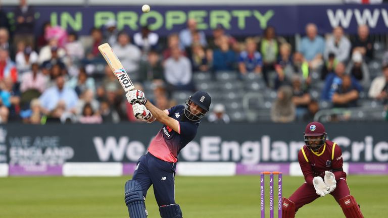 Moeen Ali of England hits out off the bowling of Ashley Nurse as wicketkeeper Shai Hope of West Indies looks on