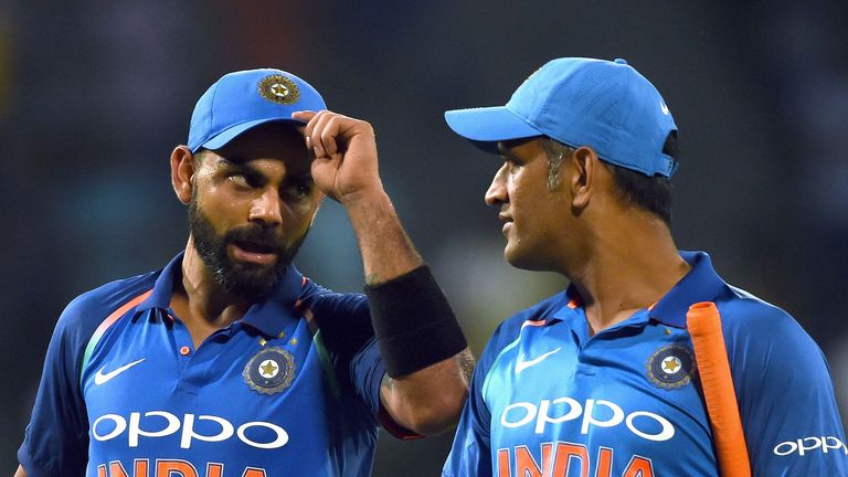 Indian cricket captain Virat Kohli (L) celebrates with teammate Mahendra Singh Dhoni (R) after victory in the final one day international (ODI) cricket mat
