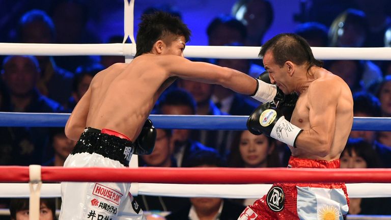 Naoya Inoue of Japan (L) defeated Omar Andres Narvaez to become a two-weight world champion in just his eighth fight