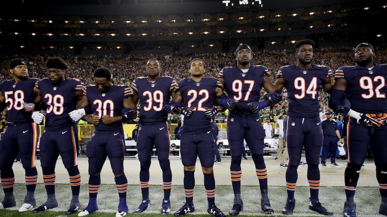 GREEN BAY, WI - SEPTEMBER 28:  Members of the Chicago Bears link arms during the singing of the national anthem before the game against the Green Bay Packe