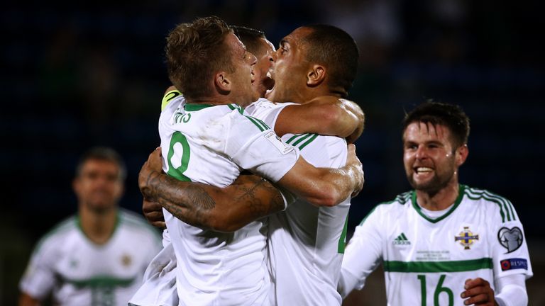 Northern Ireland's midfielder Josh Magennis (2nd R) celebrates with teammates after scoring during the 2018 FIFA World Cup qualifying football match San Ma