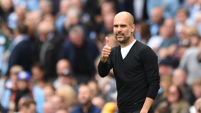 Manchester City's Spanish manager Pep Guardiola gives a thumbs up after City scored their second goal during the English Premier League football match betw