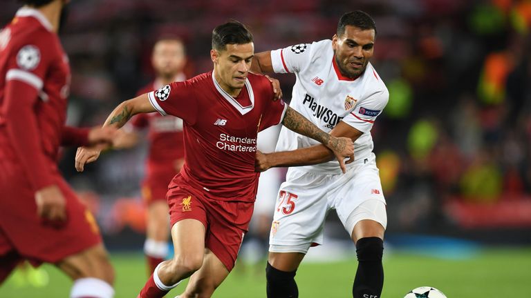 Philippe Coutinho vies with Gabriel Mercado during the UEFA Champions League Group E football match at Anfield