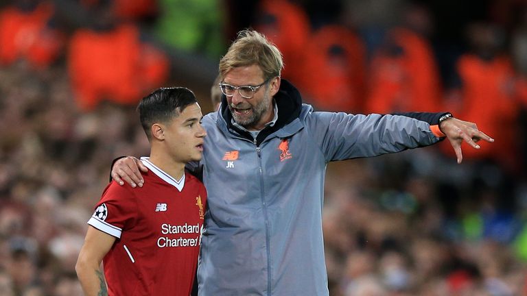 Philippe Coutinho prepares to be subbed on by Liverpool manager Jurgen Klopp during the UEFA Champions League, Group E match v Sevilla at Anfield