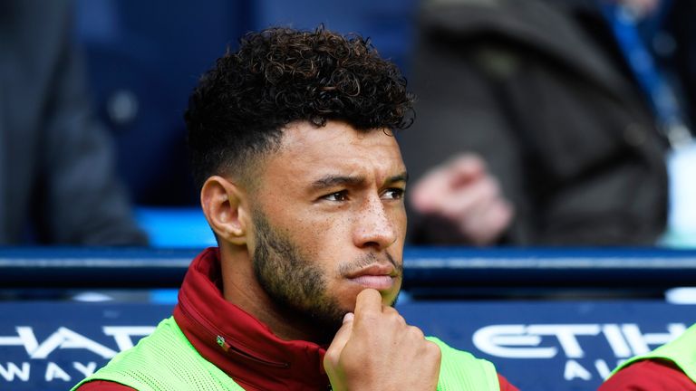 Alex Oxlade-Chamberlain takes his palce on the Livepool bench prior to kick off at the Etihad Stadium