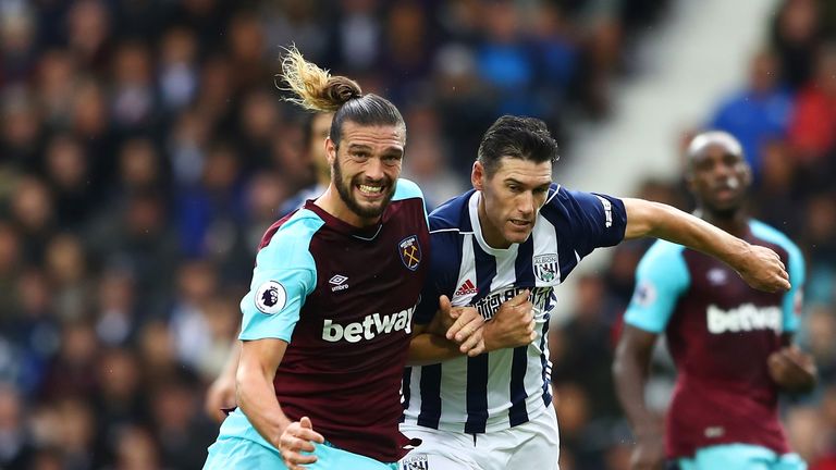 Andy Carroll and Gareth Barry compete for possession at The Hawthorns