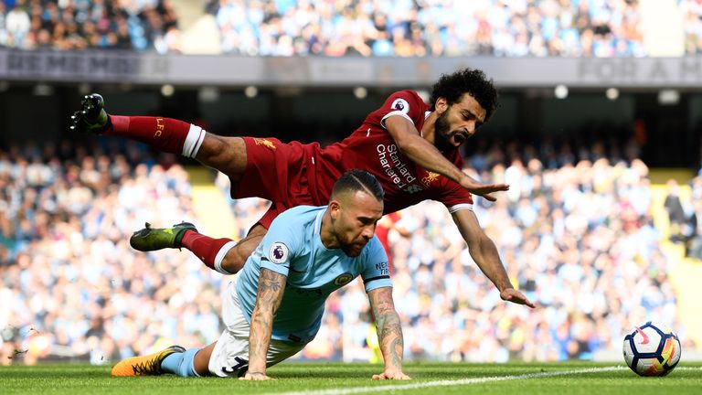 Mohamed Salah goes down under a challenge from Nicolas Otamendi
