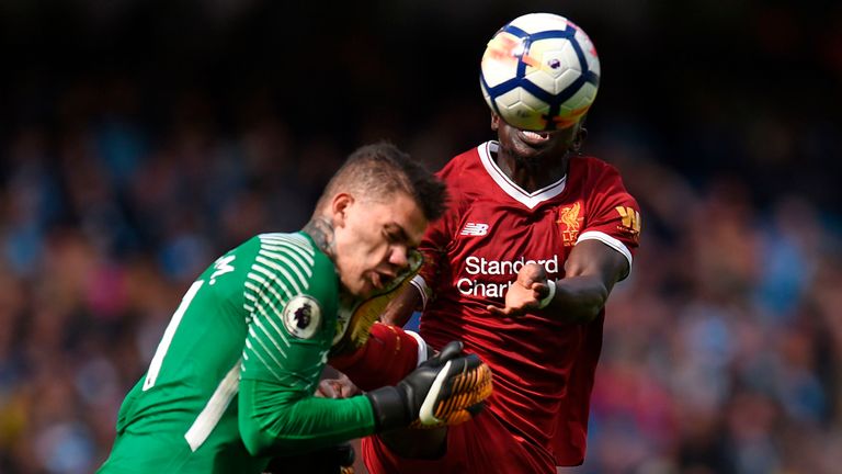 Sadio Mane catches Ederson with his boot as they challenge for the ball