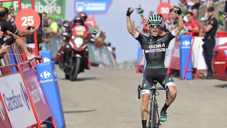 Bora-Hansgrohe's Polish cyclist Rafal Majka celebrates while crossing the finish line of the 14th stage of the Vuelta a Espana