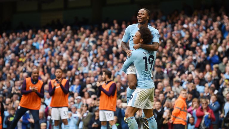 Raheem Sterling (top) celebrates after scoring with team-mate Leroy Sane