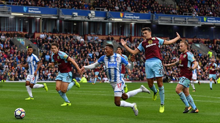 Huddersfield Town's Rajiv van La Parra goes down in the area but is booked for simulation.