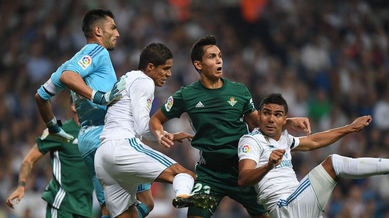 Real Madrid's Raphael Varane (2L) and Casemiro (R) vie with Real Betis' defender Aissa Mandi and Antonio Adan 