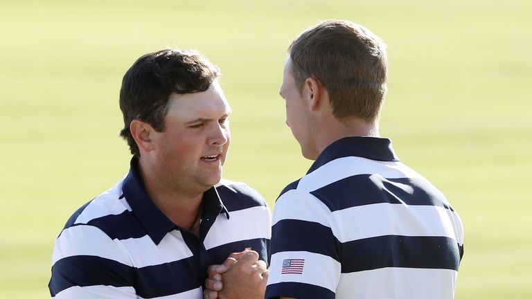 JERSEY CITY, NJ - SEPTEMBER 28:  Patrick Reed and Jordan Spieth of the U.S. Team celebrate defeating Emiliano Grillo of Argentina and the International Tea