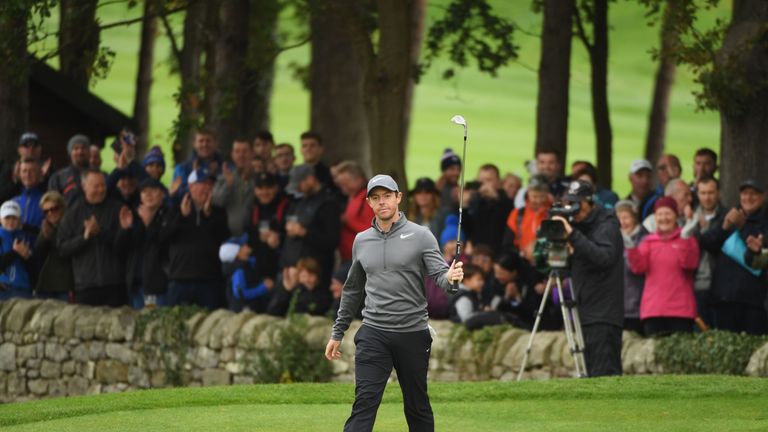 Rory McIlroy of Northern Ireland acknowledges the crowd as he chips in for a birdie on the 5th hole during day 3 of the British Masters