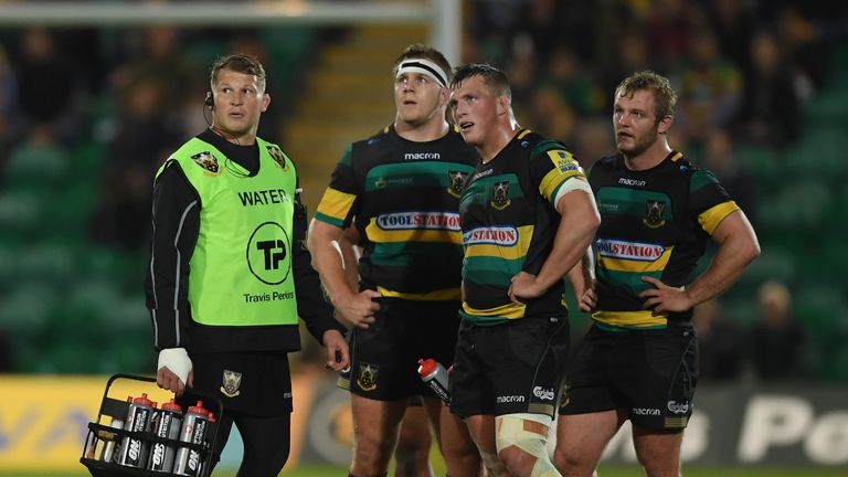 Dylan Hartley carries the water bottles during Northampton's game against Bath