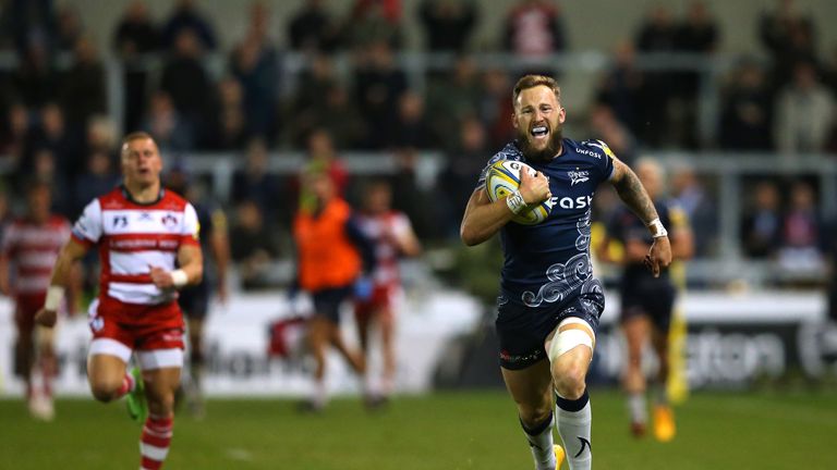 Byron McGuigan of Sale Sharks breaks away to score his third try against Gloucester