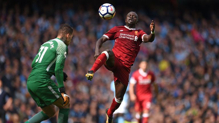 Liverpool's Senegalese midfielder Sadio Mane (R) is sent off for this challenge on Manchester City's Brazilian goalkeeper Ederson during the English Premie