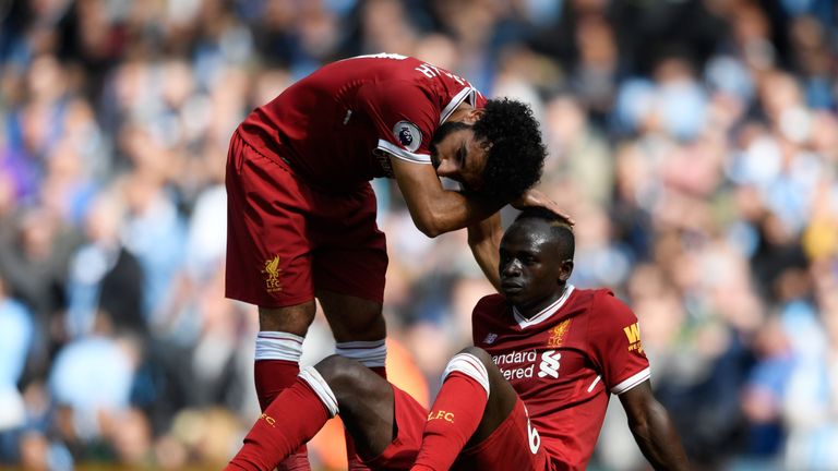MANCHESTER, ENGLAND - SEPTEMBER 09: Mohamed Salah of Liverpool comforts Sadio Mane of Liverpool after he reacts to being sent off during the Premier League