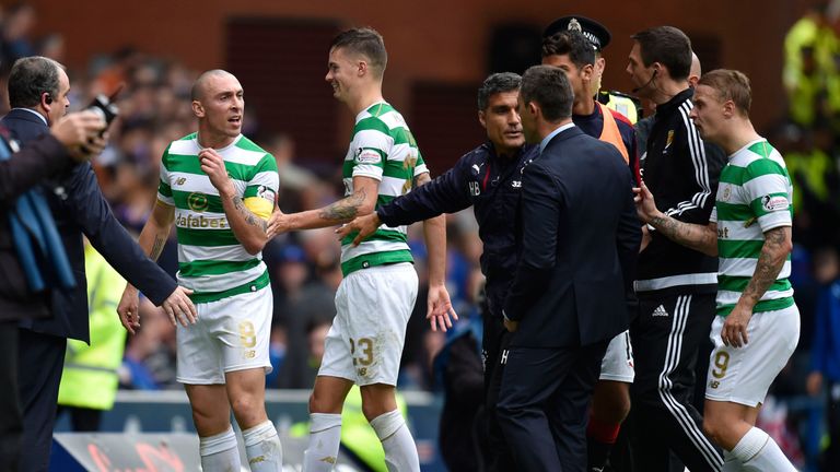 Celtic's Scott Brown (left) exchanges words with Rangers manager Pedro Caixinha at half time