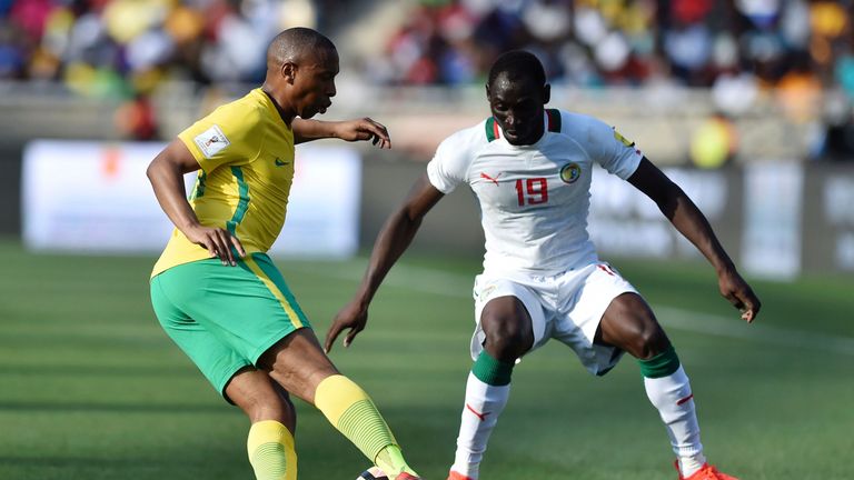 South Africa's Andile Jali (L) passes Senegal's Saliou Ciss (R)  during the 2018 World Cup qualifying football match between South Africa and Senegal
