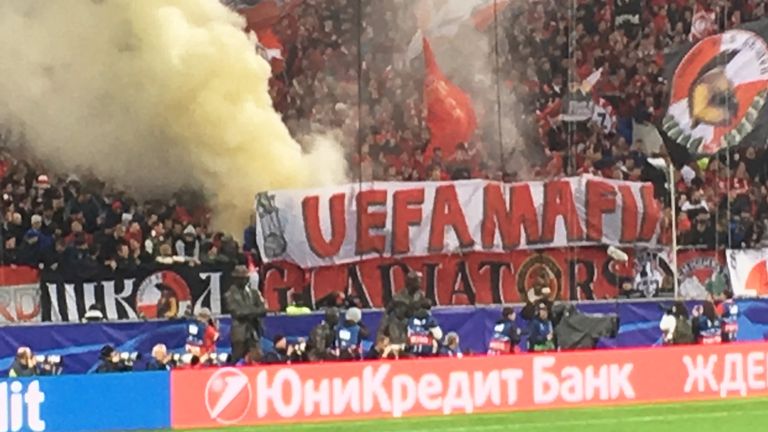 A banner is displayed and flares are set off in the stands during the UEFA Champions League match between Spartak Moscow and Liverpool