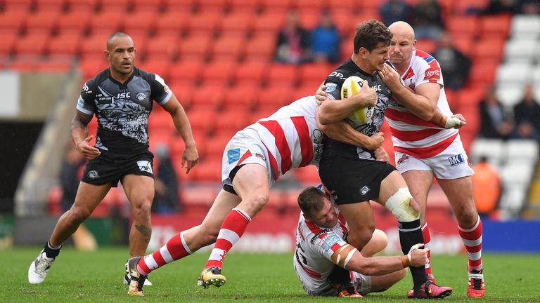 Catalans Dragons' Greg Bird is stopped by the Leigh Centurions defence during the Betfred Super League Million Pound Game at Leigh Sports Village