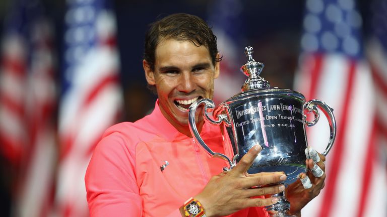 Rafael Nadal of Spain bites the championship trophy during the trophy ceremony after their Men's Singles Finals match at US Open