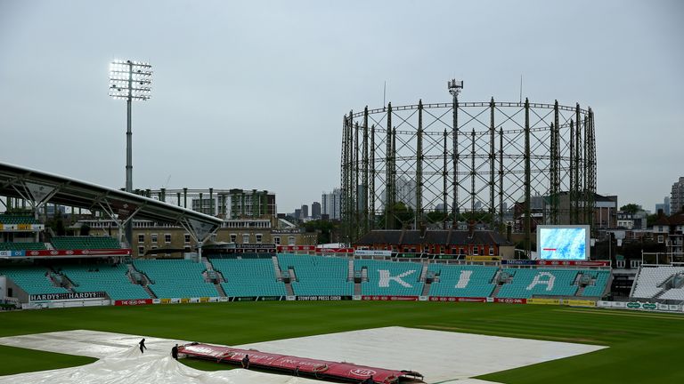 LONDON, ENGLAND - AUGUST 30:  Groundstaff pull the covers on as rain delays the start of play on day three of the Specsavers County Championship Division O