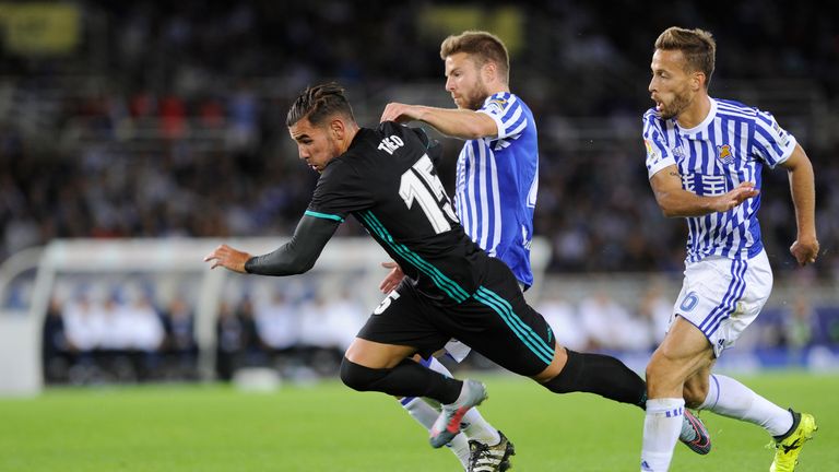 Real Madrid defender Theo Hernandez (L) vies with Real Sociedad midfielder Asier Illarramendi (C)