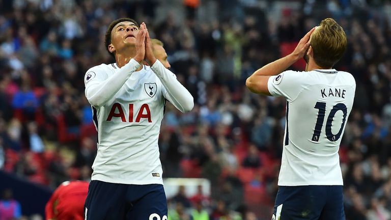 Tottenham Hotspur's English midfielder Dele Alli (L) and Tottenham Hotspur's English striker Harry Kane react to  missing a chance during the English Premi