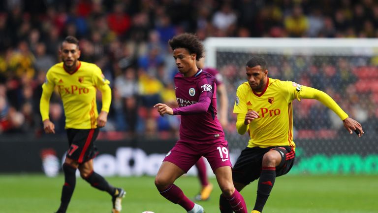 Leroy Sane of Manchester City (centre) gets away from Etienne Capoue of Watford (right)