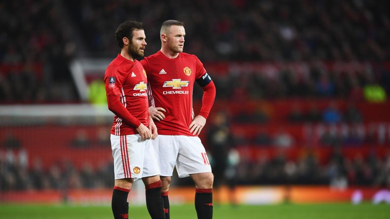 Wayne Rooney and Juan Mata of Manchester United line up a free-kick during the Emirates FA Cup Fourth round match