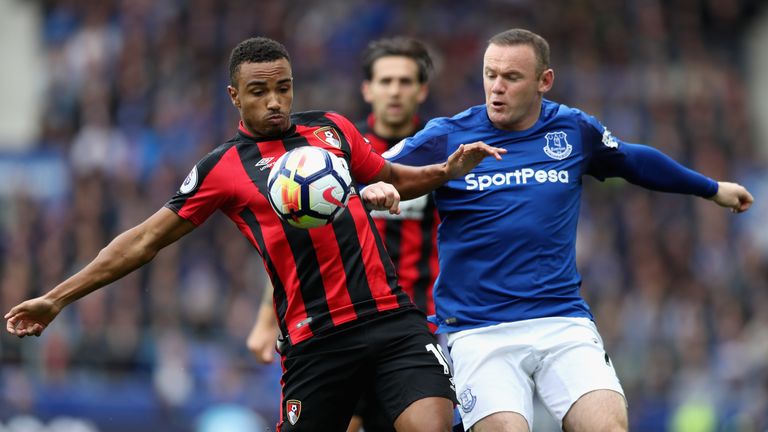 Wayne Rooney, right, and Junior Stanislas, left, battle for the ball. 