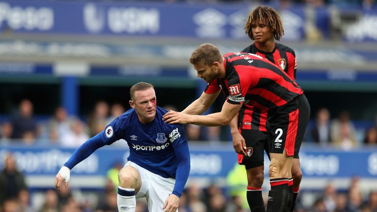 LIVERPOOL, ENGLAND - SEPTEMBER 23: Simon Francis of AFC Bournemouth checks if Wayne Rooney of Everton is okay during the Premier League match between Evert