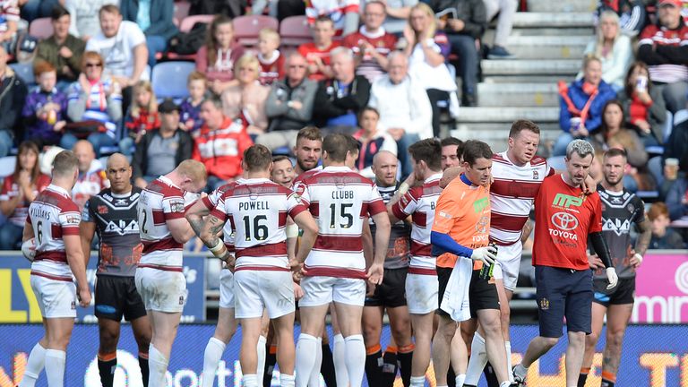 - DW Stadium, Wigan, England - Wigan's Joe Burgess (right) leaves the field injured