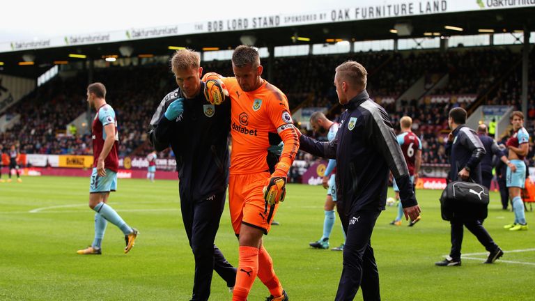 Burnley captain Heaton is helped off after dislocating his shoulder