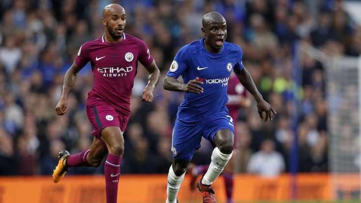 Chelsea midfielder N'Golo Kante runs away from Manchester City midfielder Fabian Delph during a Premier League football match in September 2017