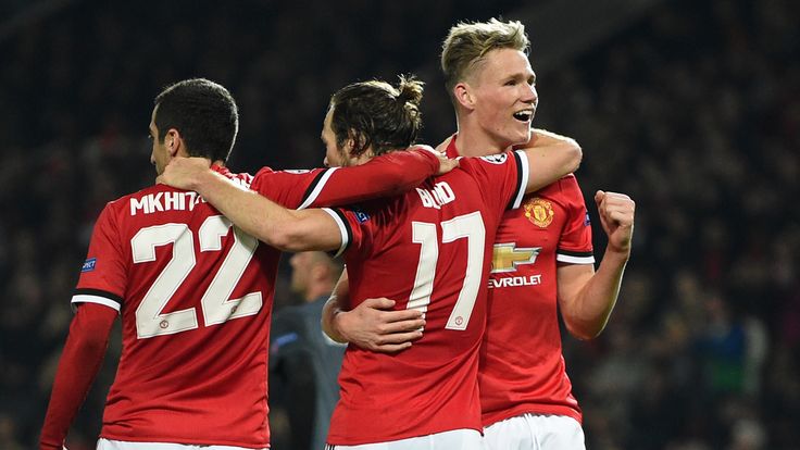 Manchester United players celebrate their second goal against Benfica