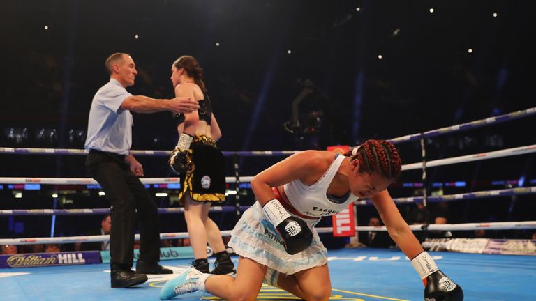 CARDIFF, WALES - OCTOBER 28:  Katie Taylor is ushered to a neutral corner as she knocks down Anahi Sanchez during their WBA Lightweight World Championship 