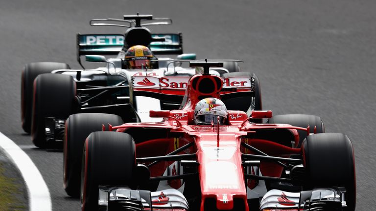 SUZUKA, JAPAN - OCTOBER 07: Sebastian Vettel of Germany driving the (5) Scuderia Ferrari SF70H leads Lewis Hamilton of Great Britain driving the (44) Merce