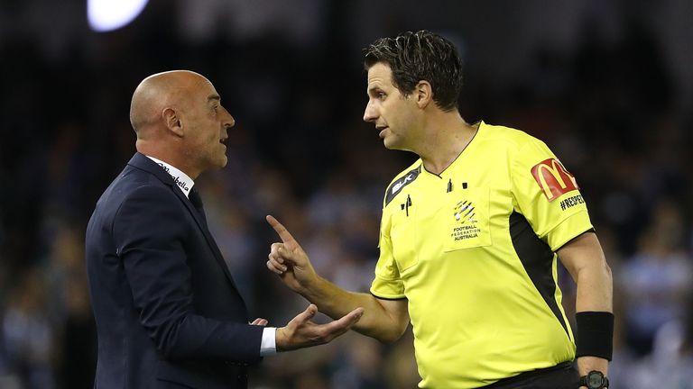 Victory coach Kevin Muscat is spoken to by referee Kris Griffith-Jones