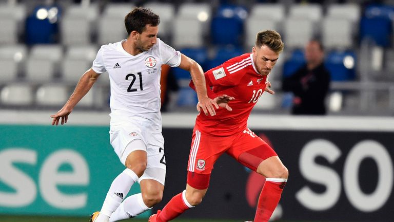 Otar Kakabadze (L) and  Aaron Ramsey vie for the ball during the FIFA World Cup 2018 qualification match between Georgia and Wales