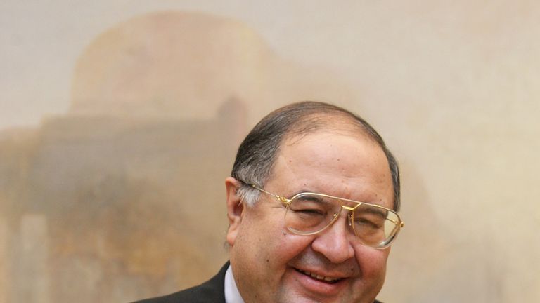 LONDON - NOVEMBER 07:  Russian oligarch Alisher Usmanov stands in front of JMW Turner's painting ' The Harbour of Brest ' in the Tate Britain art gallery  